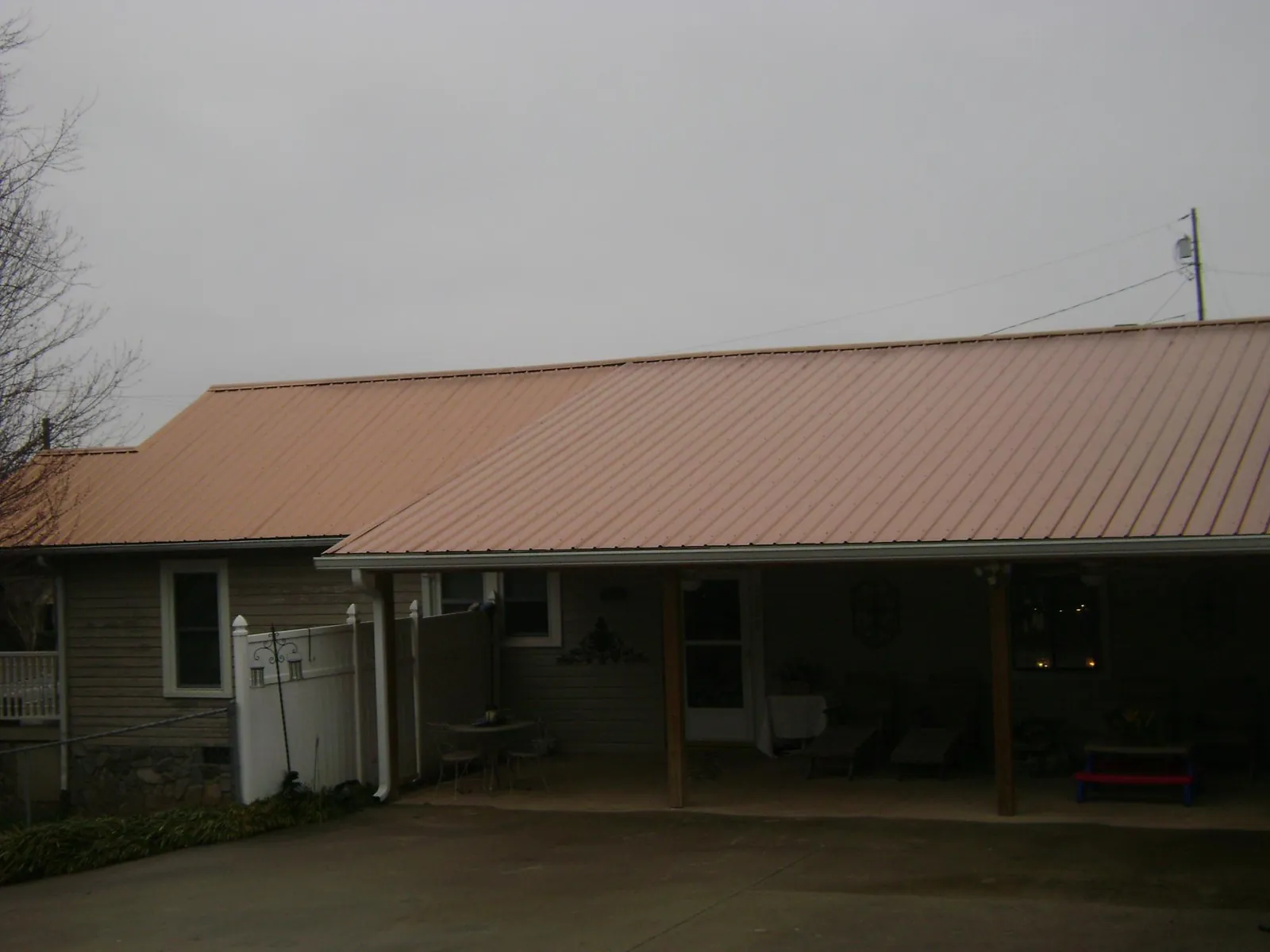 Copper toned metal roof over a wide covered patio in Whitewater